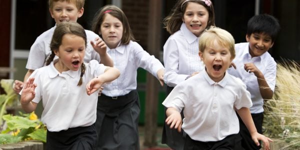 Excited primary school children leaving class school breaktimes