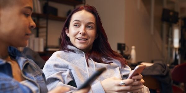 Young women chatting and using mobile phones