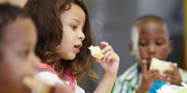 Children eating health lunch as part of free school meals