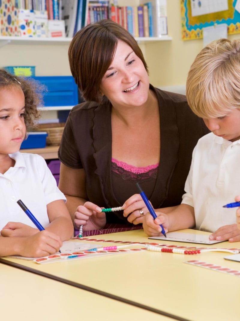Teacher with two primary school children