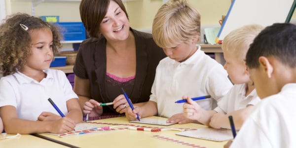 Schoolchildren and their teacher in a primary class concentrating