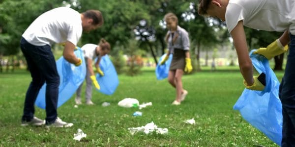 Family collecting rubbish at organised public cleaning day