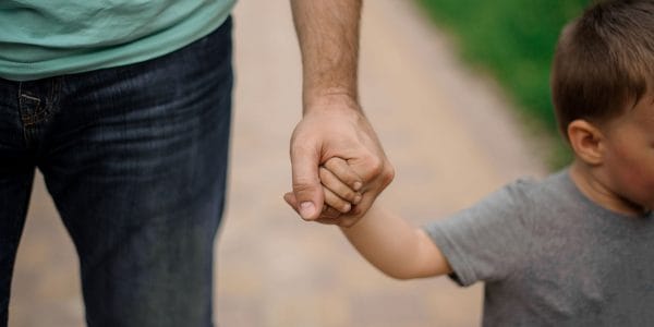 Father holds sons head