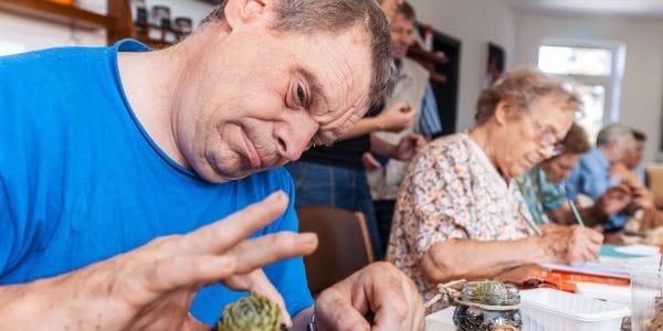 Seniors in elderly care centre doing arts and crafts