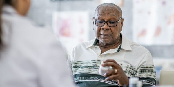 Older-man-reads-textbook-Assembling-data-jigsaw-Greater-Manchester-PROJ