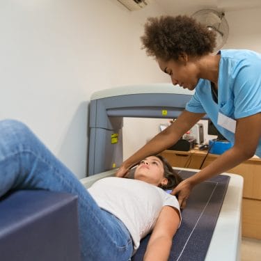 Woman-medical-professional-treats-patient-impact-MSK-conditions-outcomes-other-illnesses-PROJ