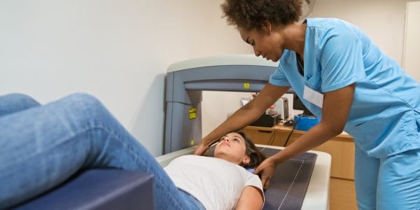 Woman-medical-professional-treats-patient-impact-MSK-conditions-outcomes-other-illnesses-PROJ