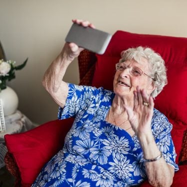Senior-woman-enjoys-video-call-on-smartphone-Social-cohesion-in-context-of-COVID-19-PROJ