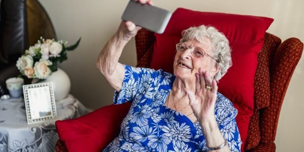 Senior-woman-enjoys-video-call-on-smartphone-Social-cohesion-in-context-of-COVID-19-PROJ