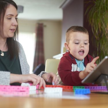 Young-boy-uses-tablet-with-mother-for-maths-learning-Can-maths-apps-add-value-to-learning-PROJ