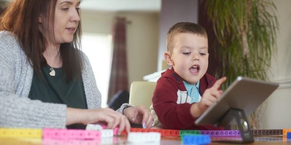 Young-boy-uses-tablet-with-mother-for-maths-learning-Can-maths-apps-add-value-to-learning-PROJ