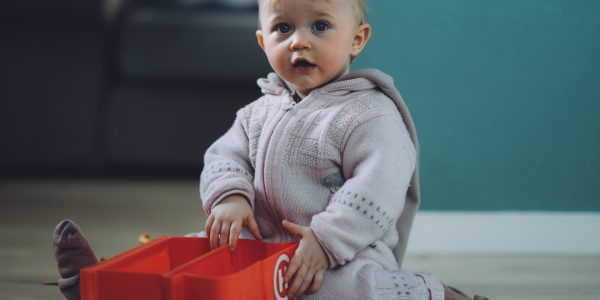 Toddler playing with toys at childcare centre during COVID-19