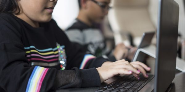 Two secondary school students learning at home during COVID-19 pandemic