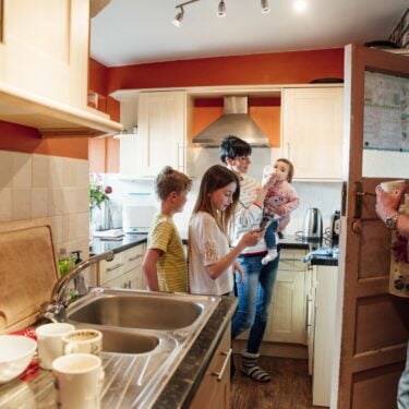 Code encounters algorithmic risk-profiling in housing: a family in their kitchen at home