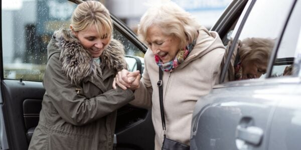 A woman helps an older woman out of a car: Latest News English councils will need billions more from government and big council tax rises to maintain services and pay for social care reforms