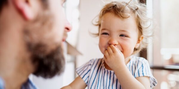 A little girl smiles at her father
