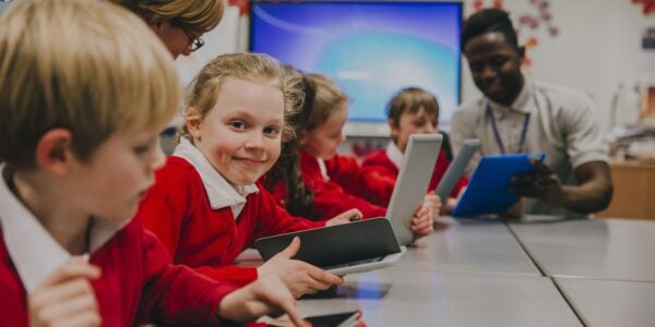 Primary school children using tablets and laptops