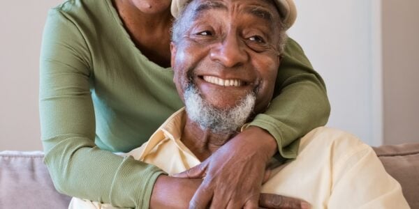 Smiling older couple at home in their living room