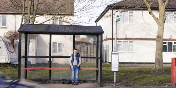 A boy waits at a bus stop: Spatial inequalities in the UK are profound and persistent
