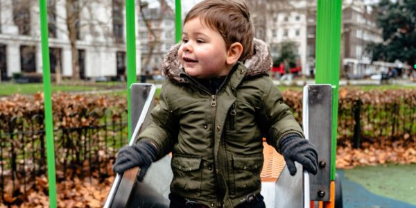 Small boy playing on a slide in a park