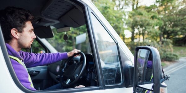 A man driving a van at work