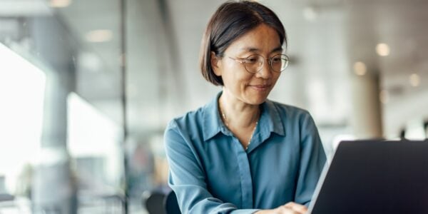 Older woman at work using a laptop
