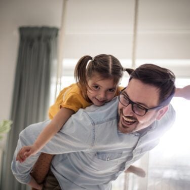 Father and daughter having fun at home