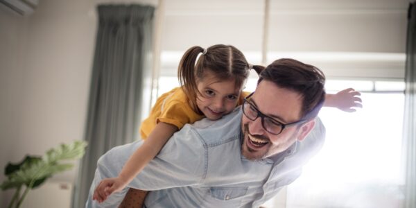 Father and daughter having fun at home