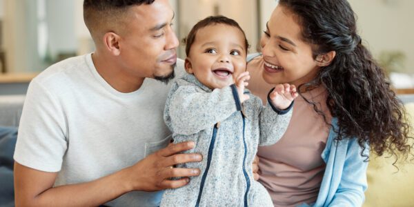 Young parents with baby, smiling
