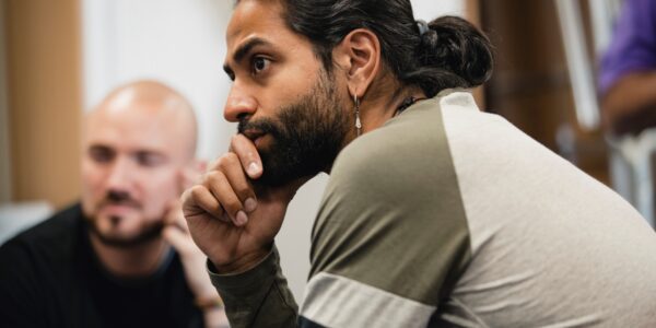 Man leading a focus group listening to the participants speaking