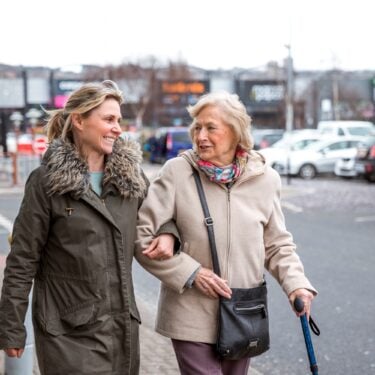 Elderly woman and adult daughter out shopping