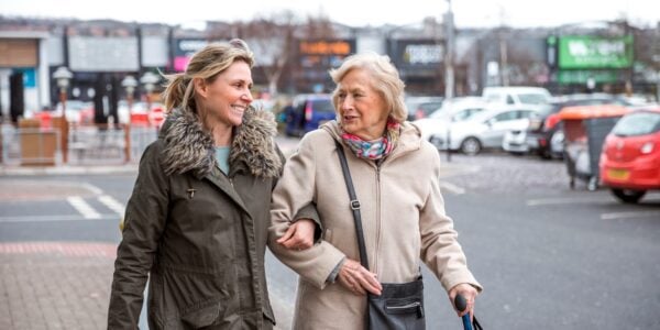 Elderly woman and adult daughter out shopping