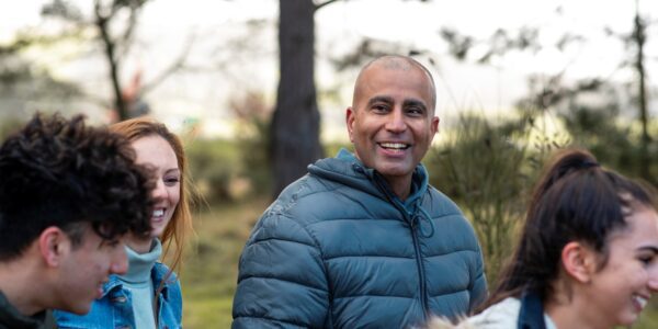 A group of neighbours walking outside in a green space
