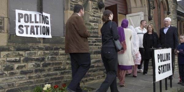 voters entering polling station to vote in election