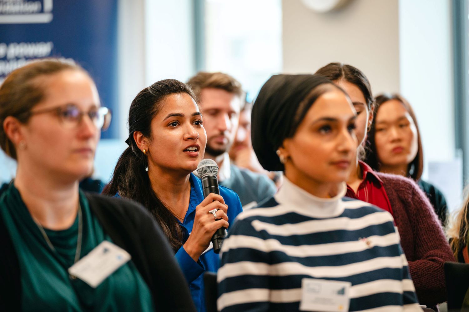 Asking a question at ECR event A woman in the audience asking a question at the ECR event