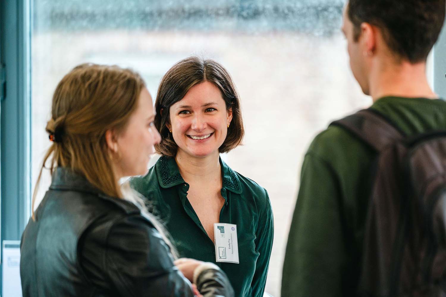 Nuffield Foundation 19 October 2023 Three people chatting and smiling at the Nuffield Foundation early career researcher event