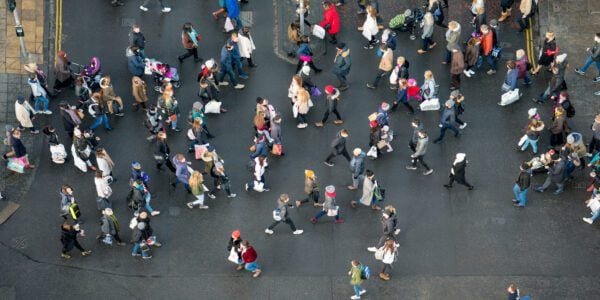 Birds-eye view of a crowd of people crossing a road