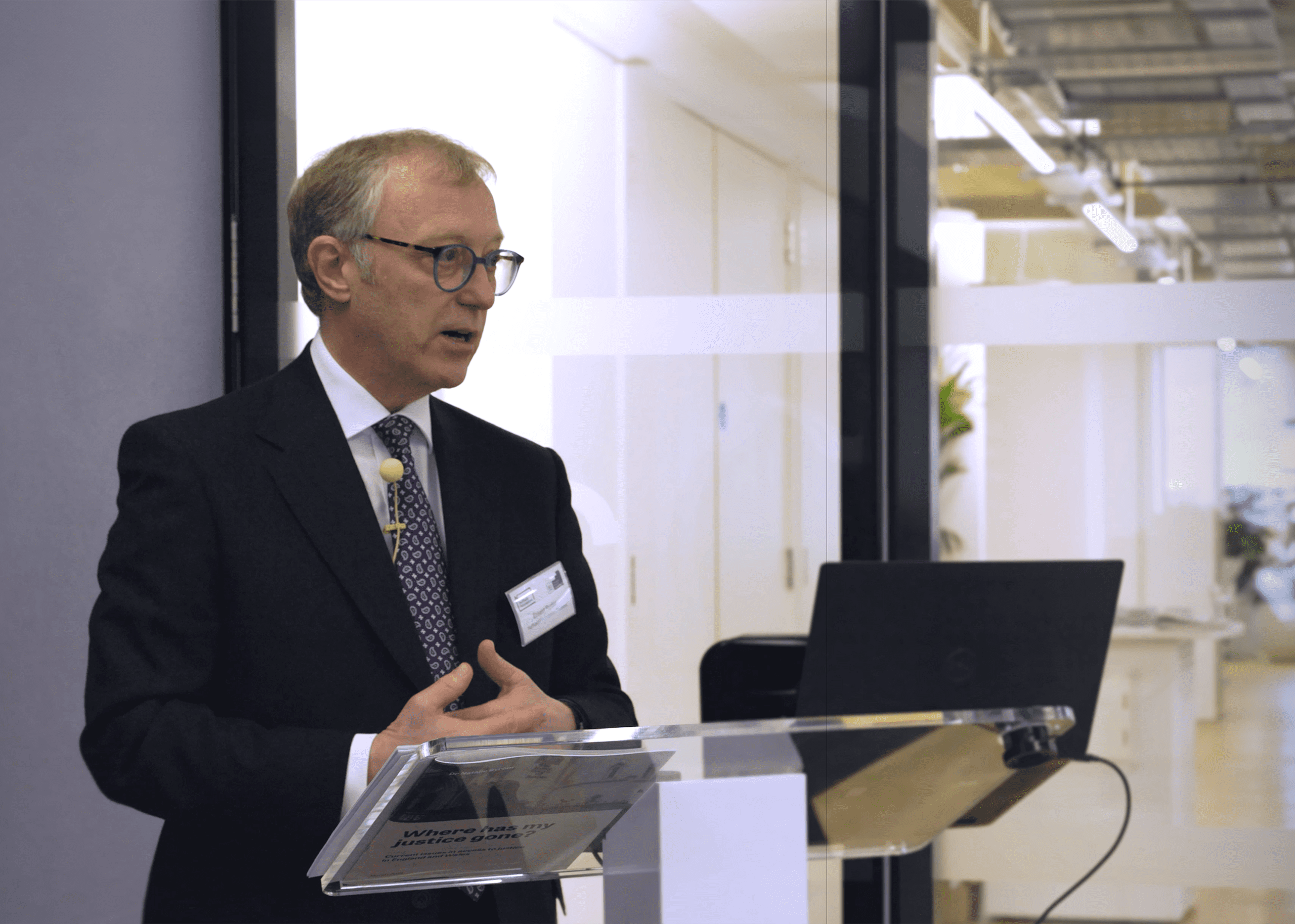 Rt Hon Sir Ernest Ryder standing at lectern giving a keynote speech the Nuffield Foundation offices