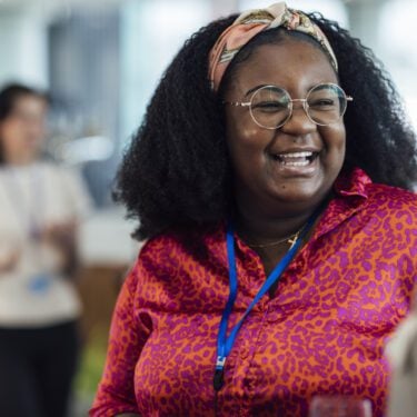 Happy woman talking to a colleague at work