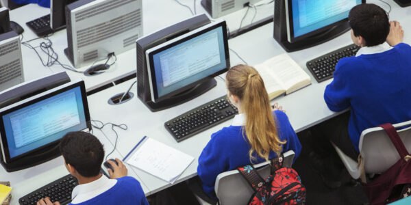 Elevated view of students sitting and learning in computer room