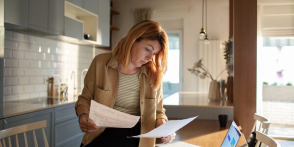 Close up of a Young woman going over her retirement savings at home while using her laptop