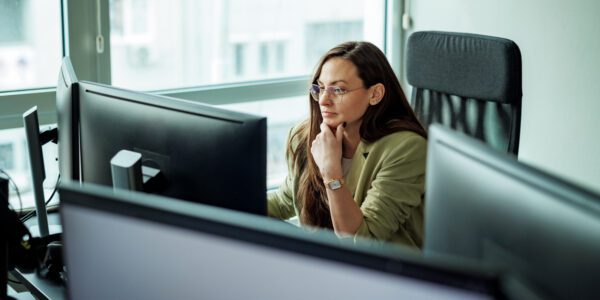 Young well dressed businesswoman working on a computer at the office