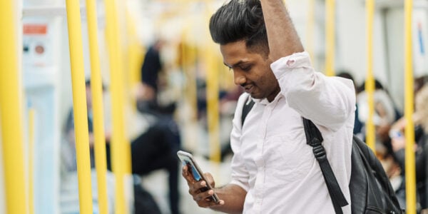 Young Indian man travelling to and back from work by public transportation.