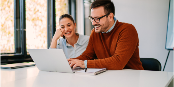 Man and younger woman on a computer