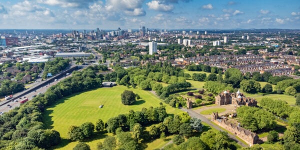 Wide angle aerial view over Aston Hall and park looking towards the skyline of Birmingham, England, UK.