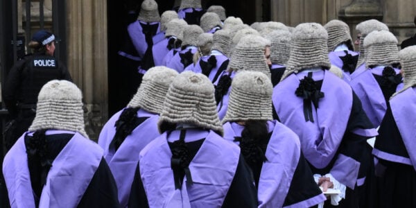 UK judges in traditional ceremonial dress with full bottomed wigs in procession at Westminster